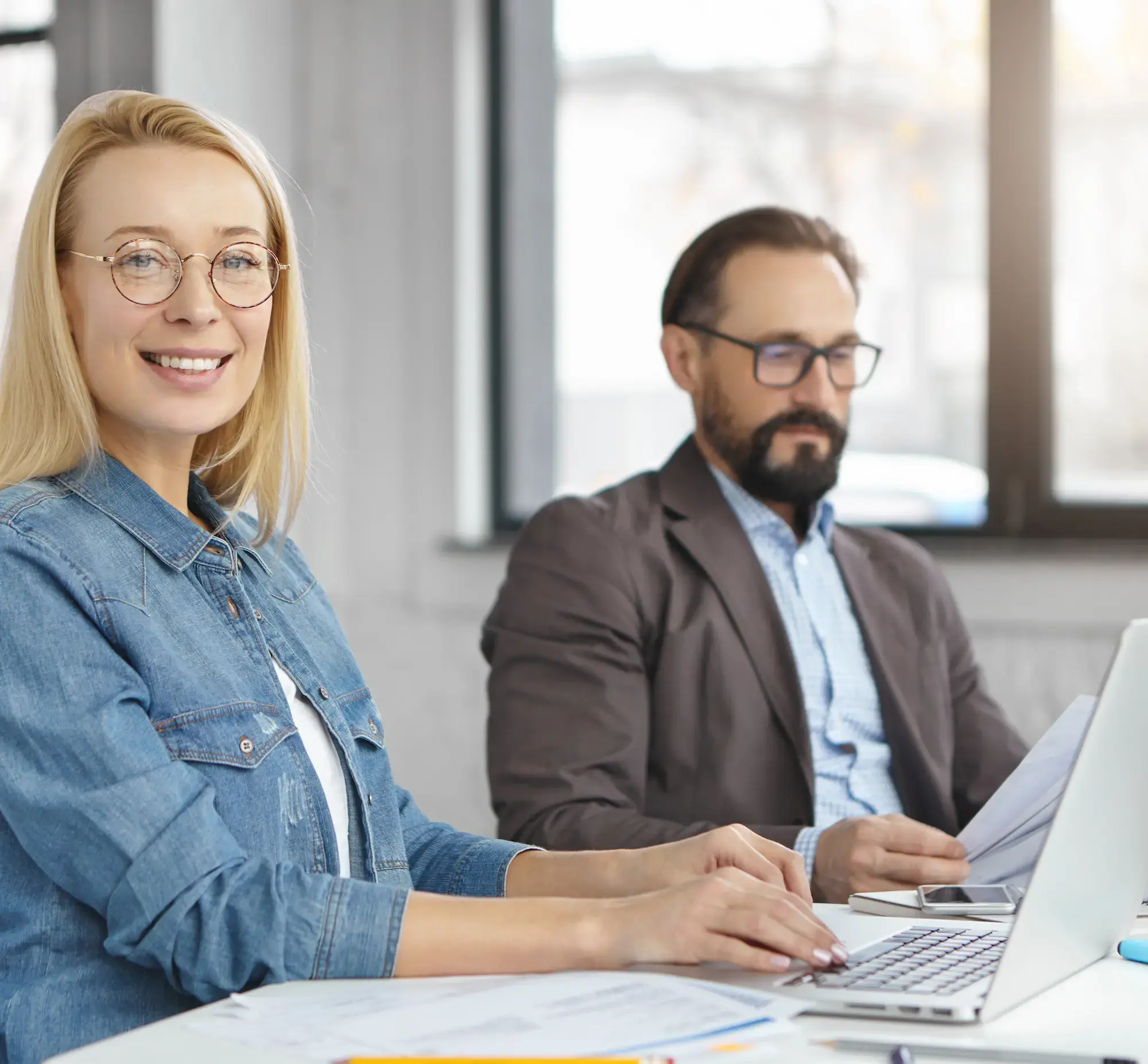 female-male-economists-work-with-documents-modern-technologies