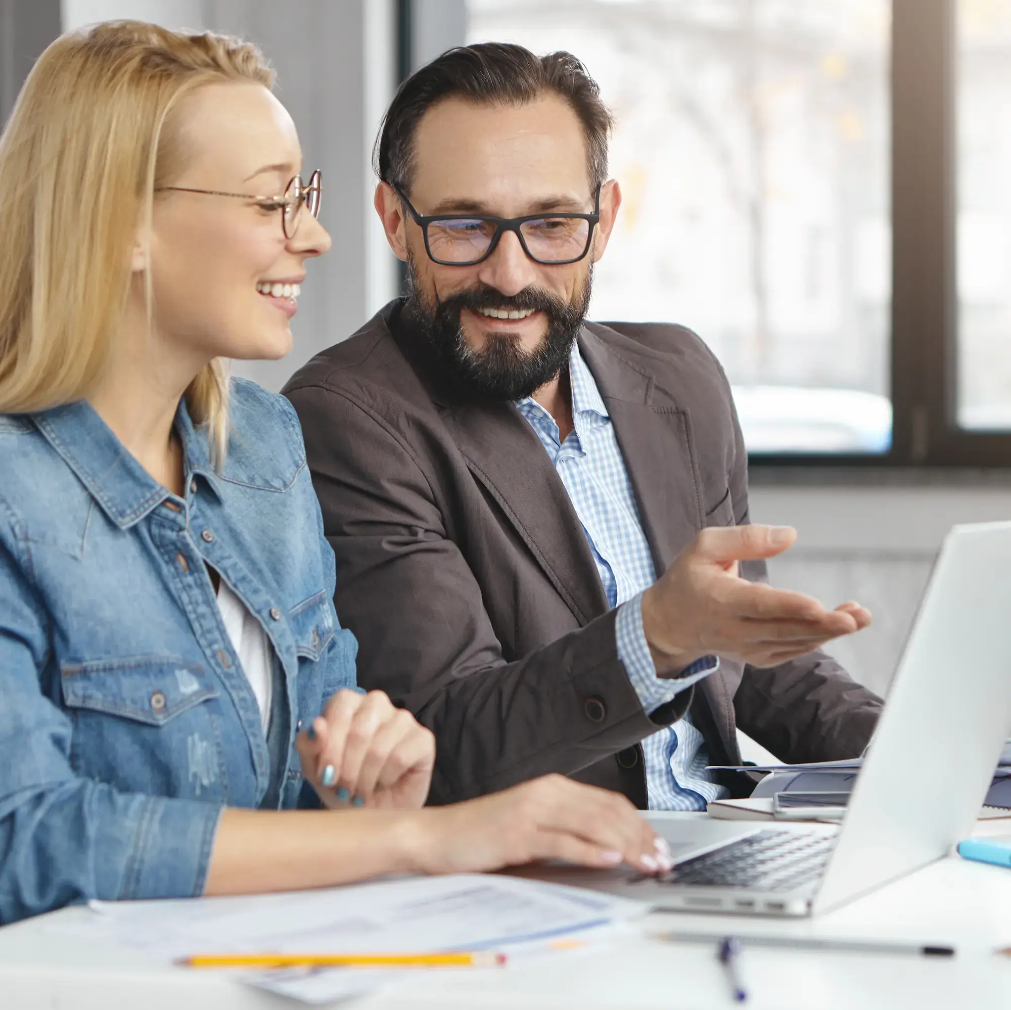 happy-blonde-female-manager-has-conversation-with-male-colleague